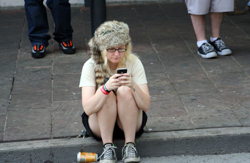 Phone user on Sixth Street