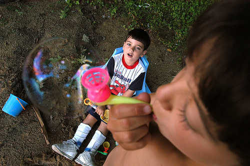 Samuel and Isaiah Habib blowing a bubble